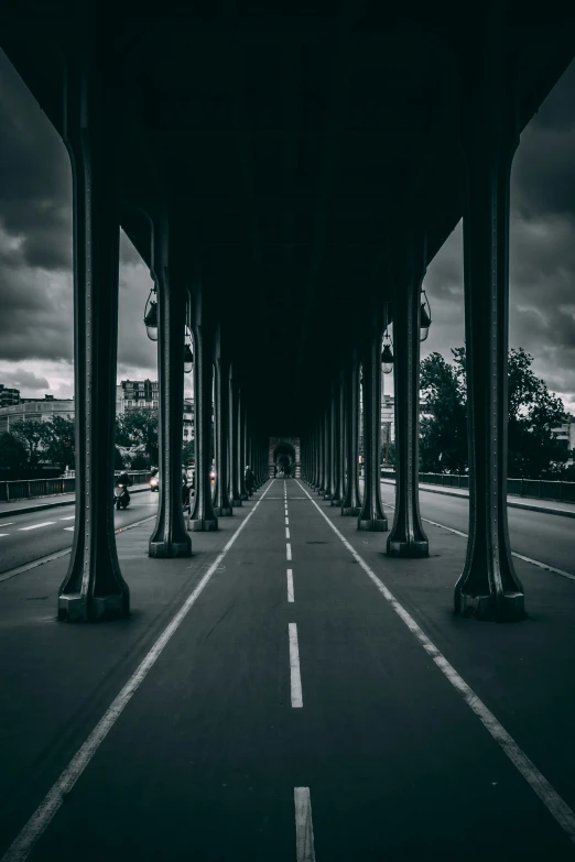 a street lined with pillars under an overpass