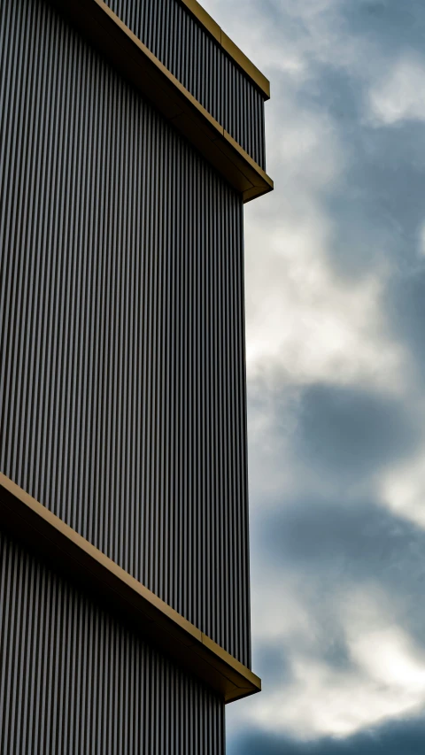 an airplane flying close to the side of a tall building