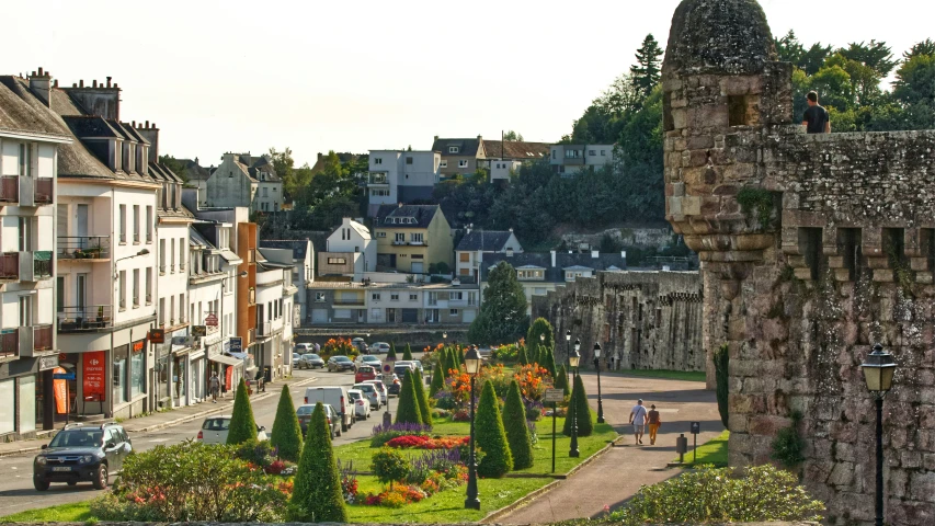 a castle wall with cars and people in front