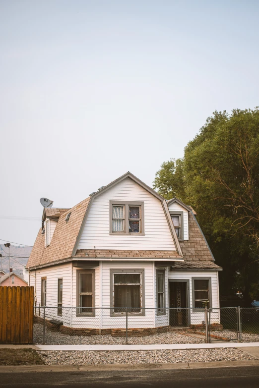 a white house with a brown roof and windows