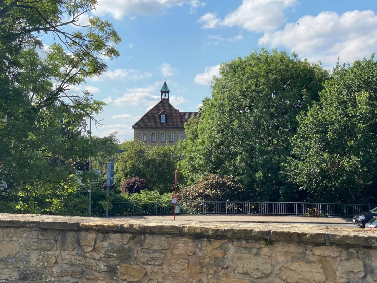 a tree lined wall behind a city park