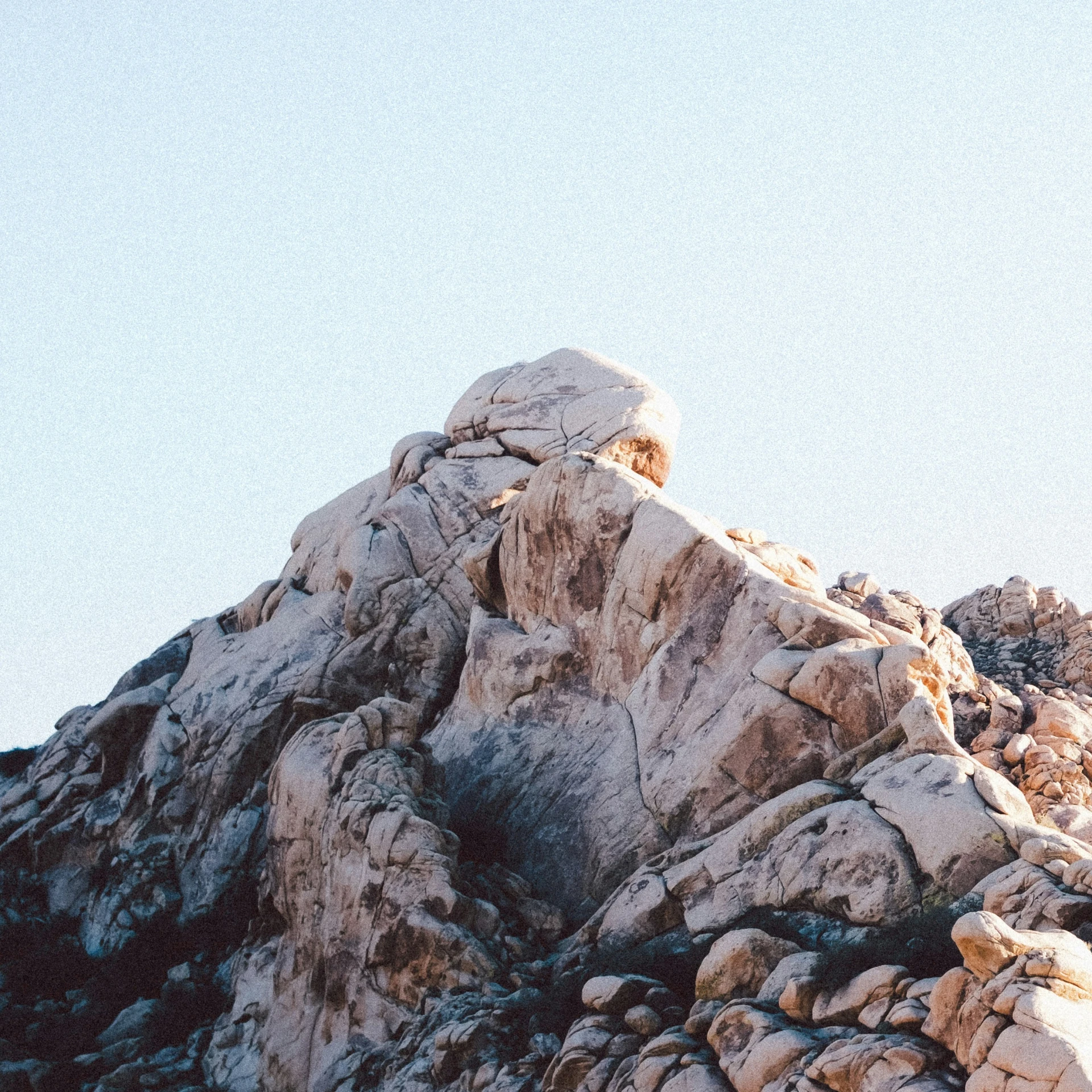 a couple people hiking on the rocky mountain side