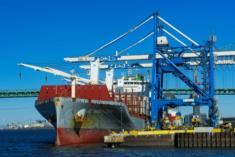 an open cargo ship next to a dock