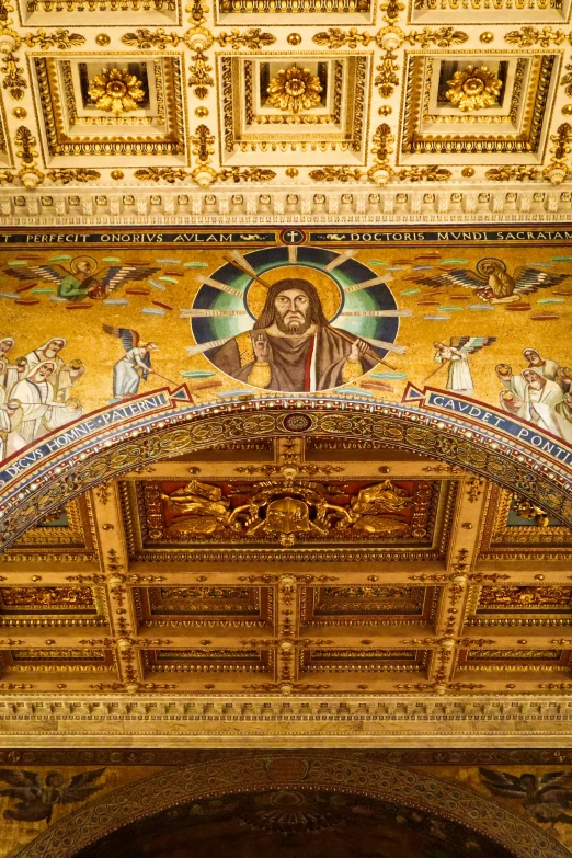 an intricate ceiling in a building with gold and white