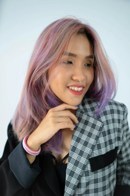 a woman with long pink hair wearing a black and white jacket