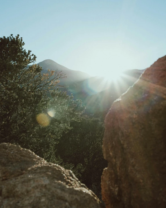 the sun shines down on mountains on a clear day