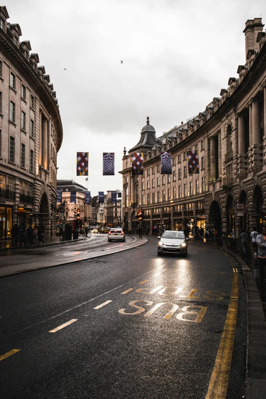 a car driving down a wet street in the rain