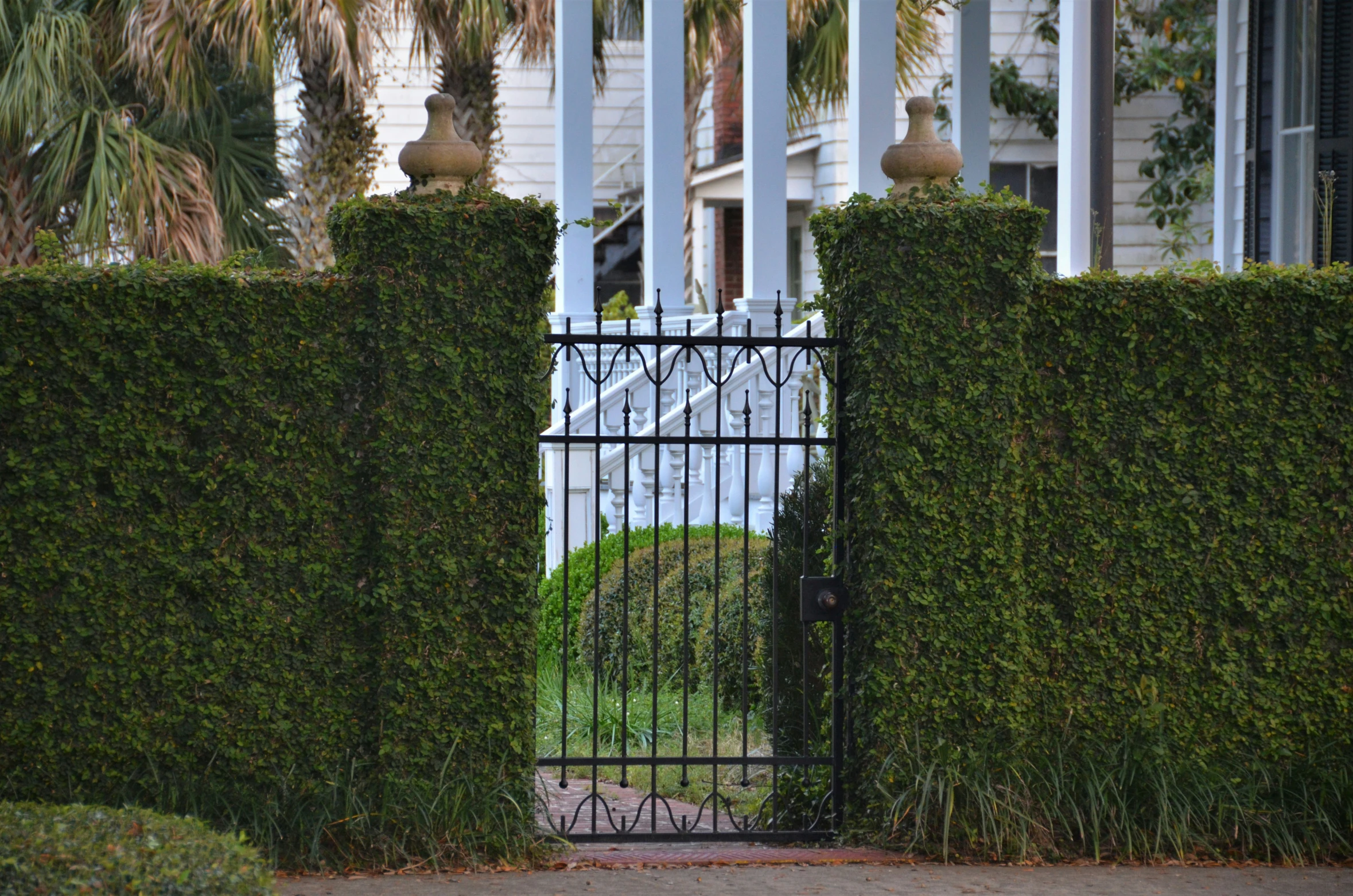 a beautiful home and an iron gate