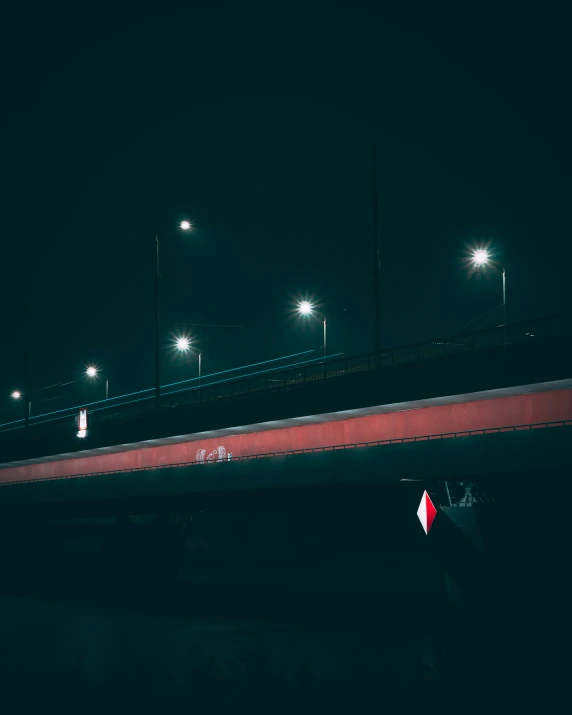 a bridge is shown illuminated at night near some street lights