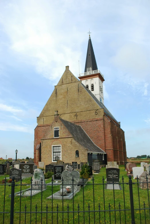 there is a church on the grass near graveyards