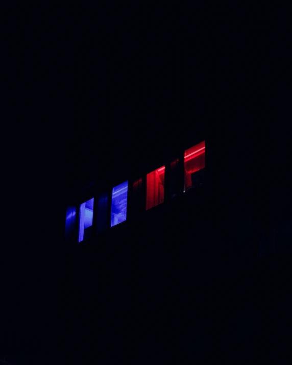 a clock is sitting on top of a building in the dark