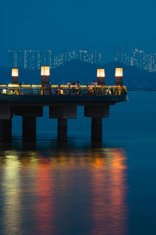 an illuminated pier with a restaurant next to it