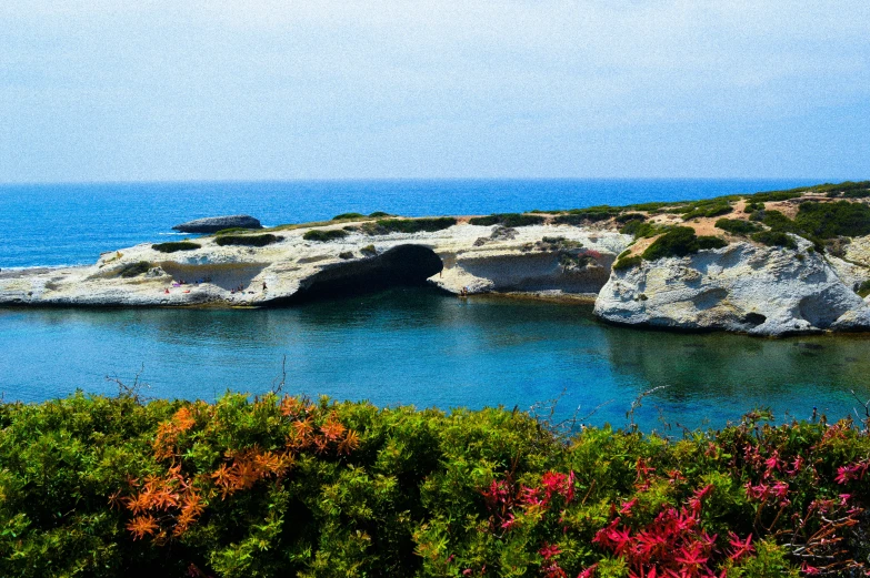 the coast is surrounded by a massive rock arch