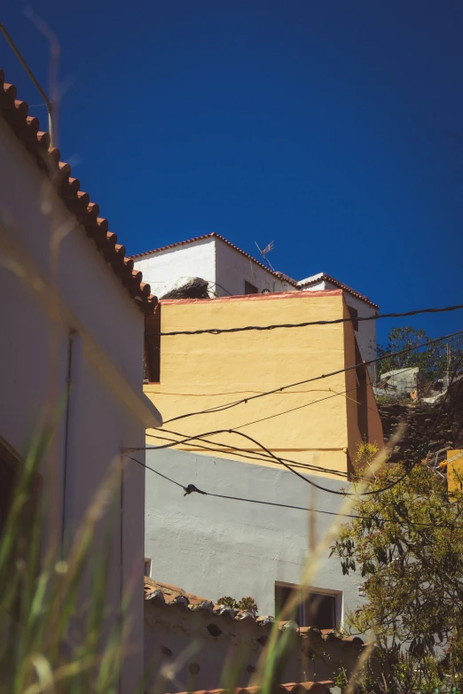 an apartment building with the top of it against a blue sky