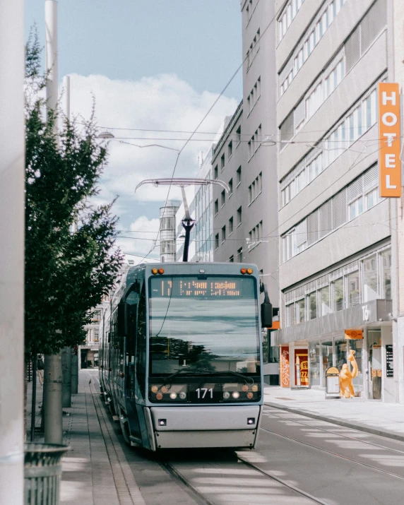 a bus on the street with a building in the background