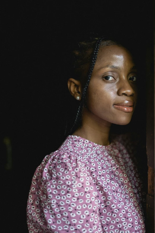 a woman standing by the door in the dark