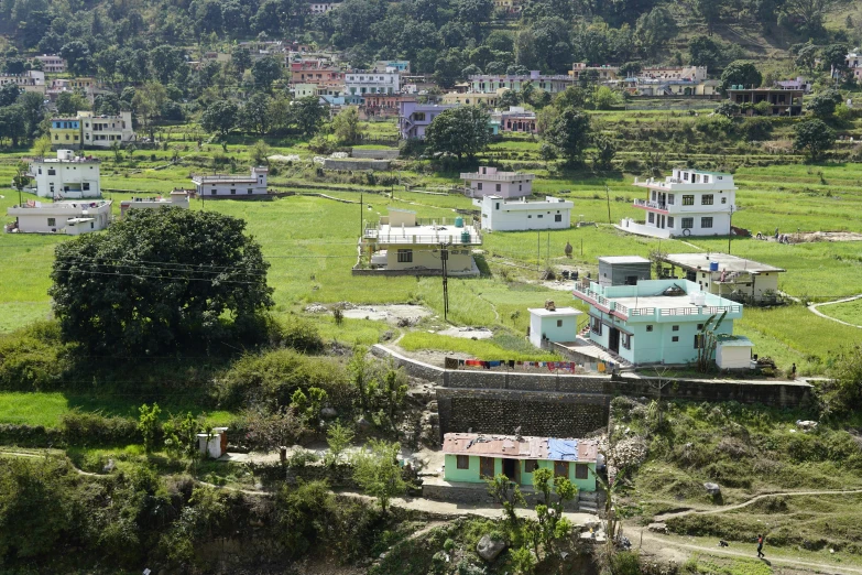 a rural area with many houses and green grass