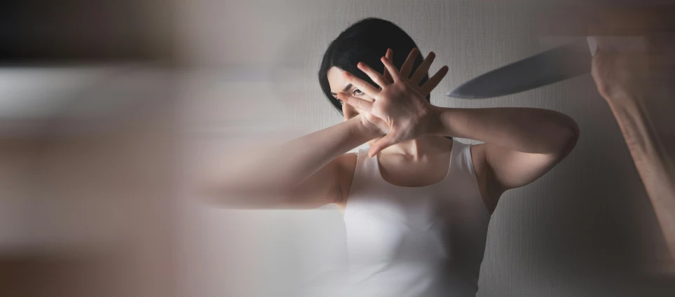 a woman holding her hands out near a mirror