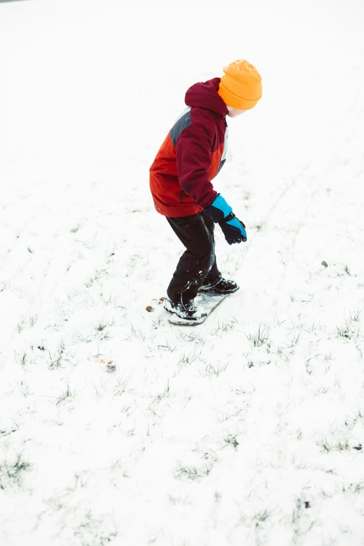 a small child in winter clothing on skis