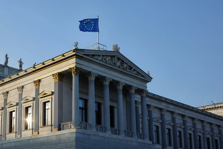 the european union of parliament building with the european flag flying over it