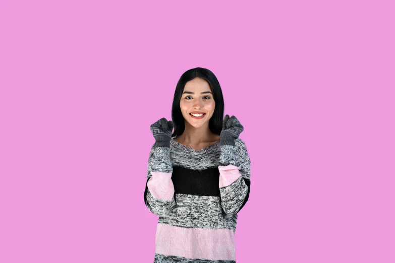 a woman in black and white clothing on a pink background