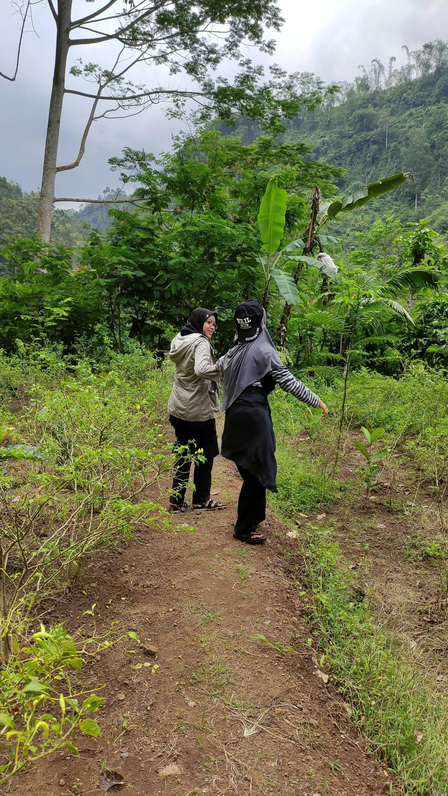 two people running towards each other on a path