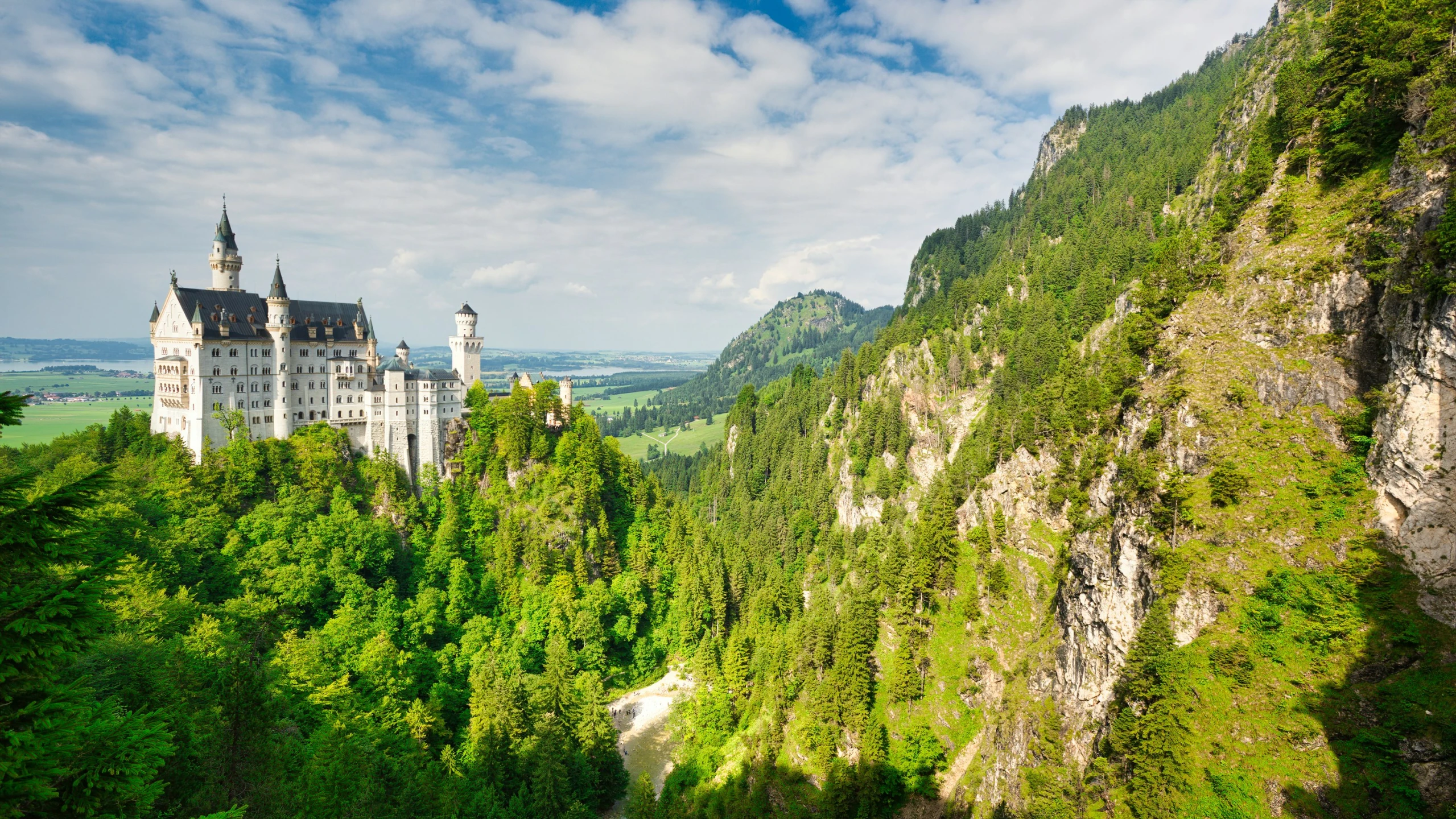 an aerial view of a castle perched on the side of a cliff