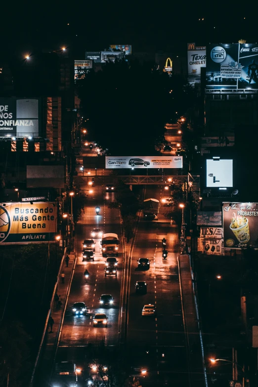 a long way street in an all lit up city at night