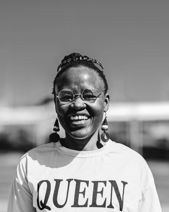 a woman in glasses smiling for the camera