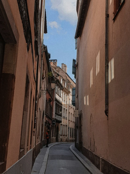 a street view from an alley way of some buildings