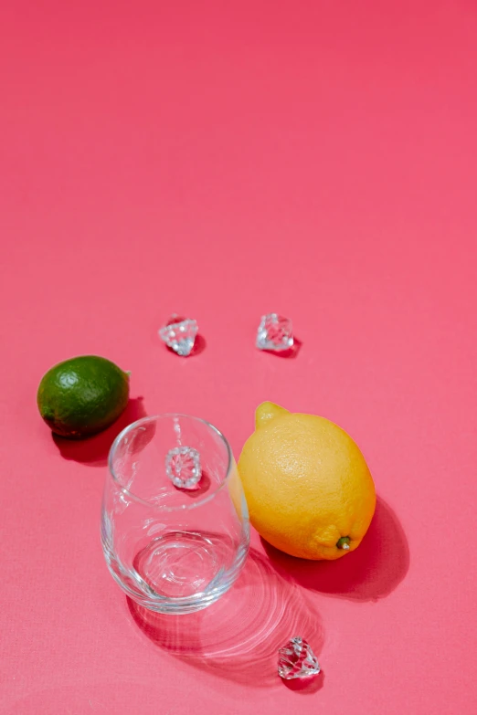 an image of two oranges and one glass with water