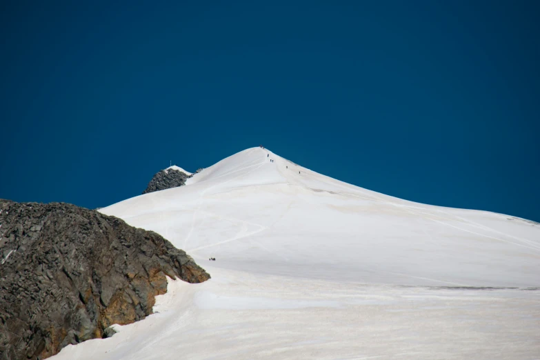 a person snowboarding on top of a snow covered mountain