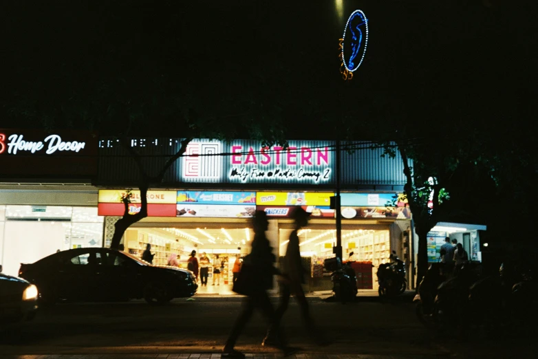 a night time s of people walking on the street