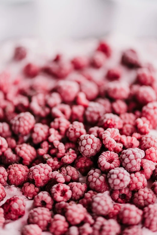 a bunch of small raspberries sitting on top of a table