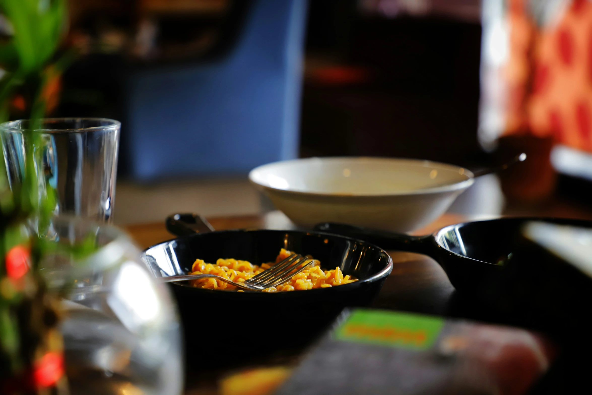 a bowl with pasta inside sits on a table