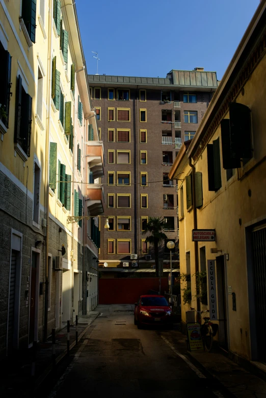 street in an urban city with a parked red car