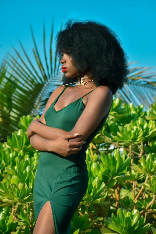 a person in a green dress posing for the camera