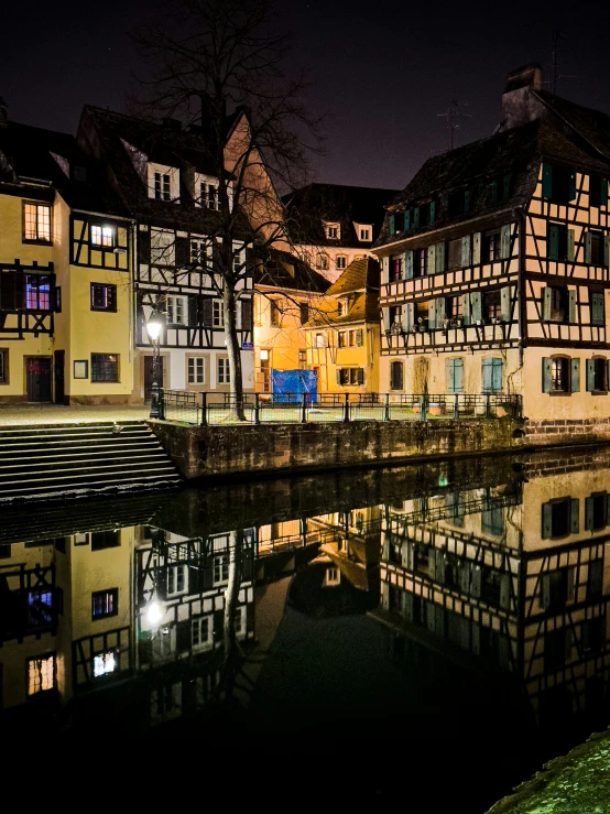 a body of water next to a row of buildings