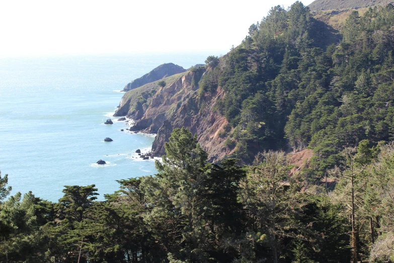 a very tall cliff near a large body of water