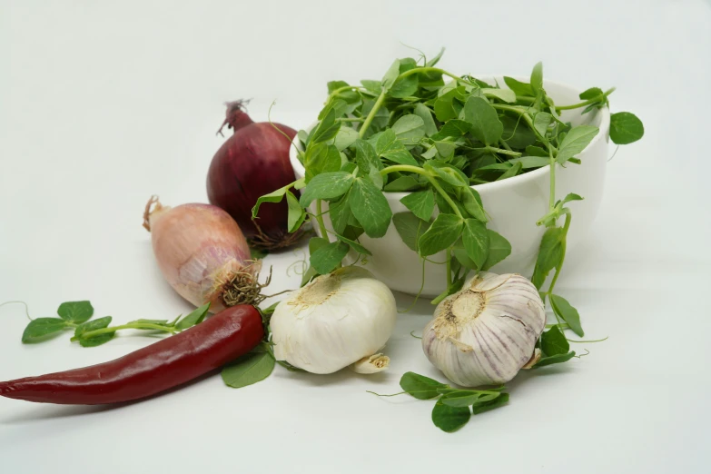 a bowl full of chopped garlic, radishes and other vegetables