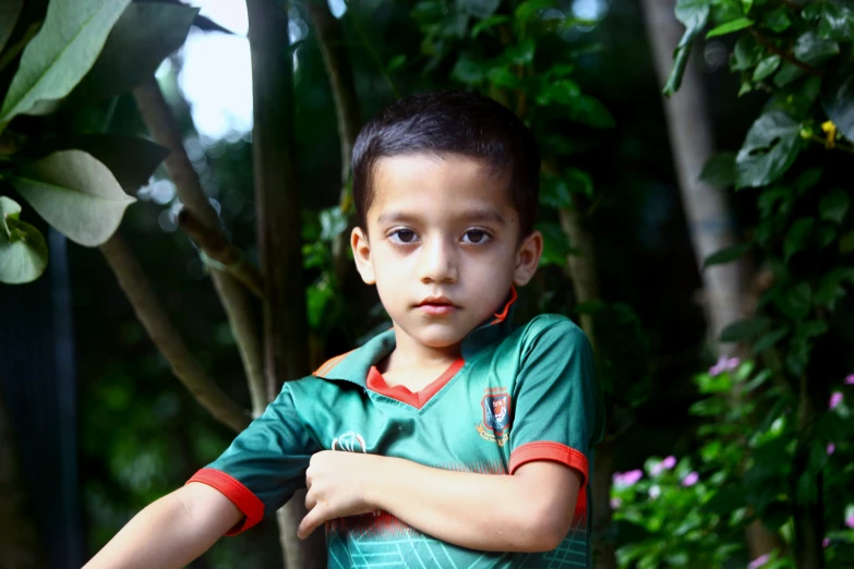 a  stands in front of some trees and bushes