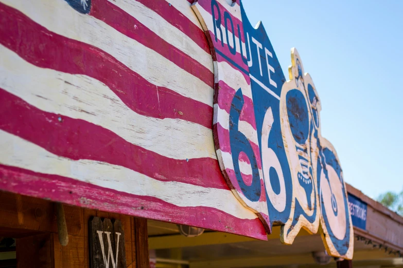 a close up of a store sign with an american flag on it