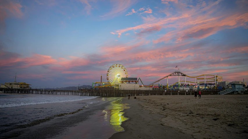 sunset at the ocean with many rides