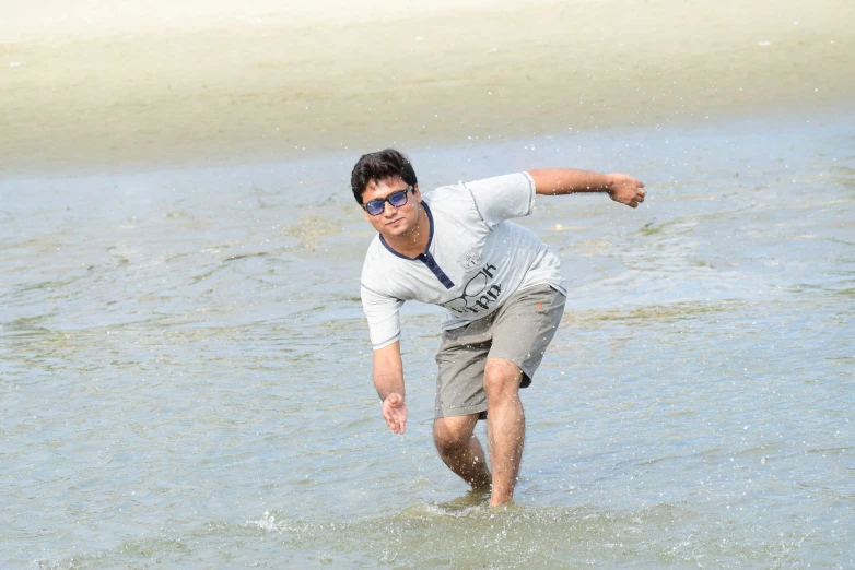 a man playing in the water on a surfboard