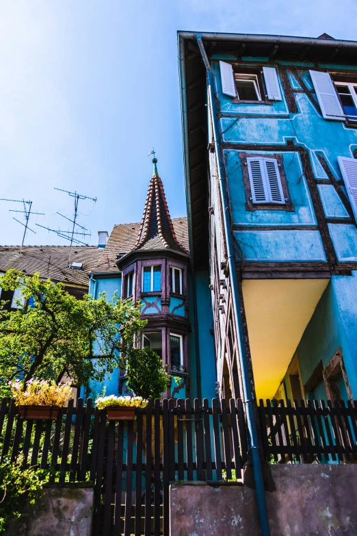 a house with the blue siding on a sunny day