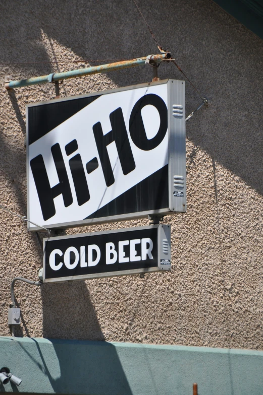 a large sign with a hi - ho message hanging from the side