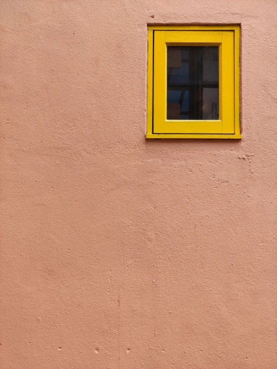 the yellow frame on the wall has an orange square