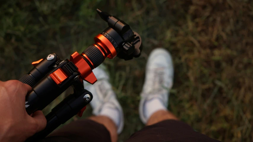 an image of a man holding a small bicycle light