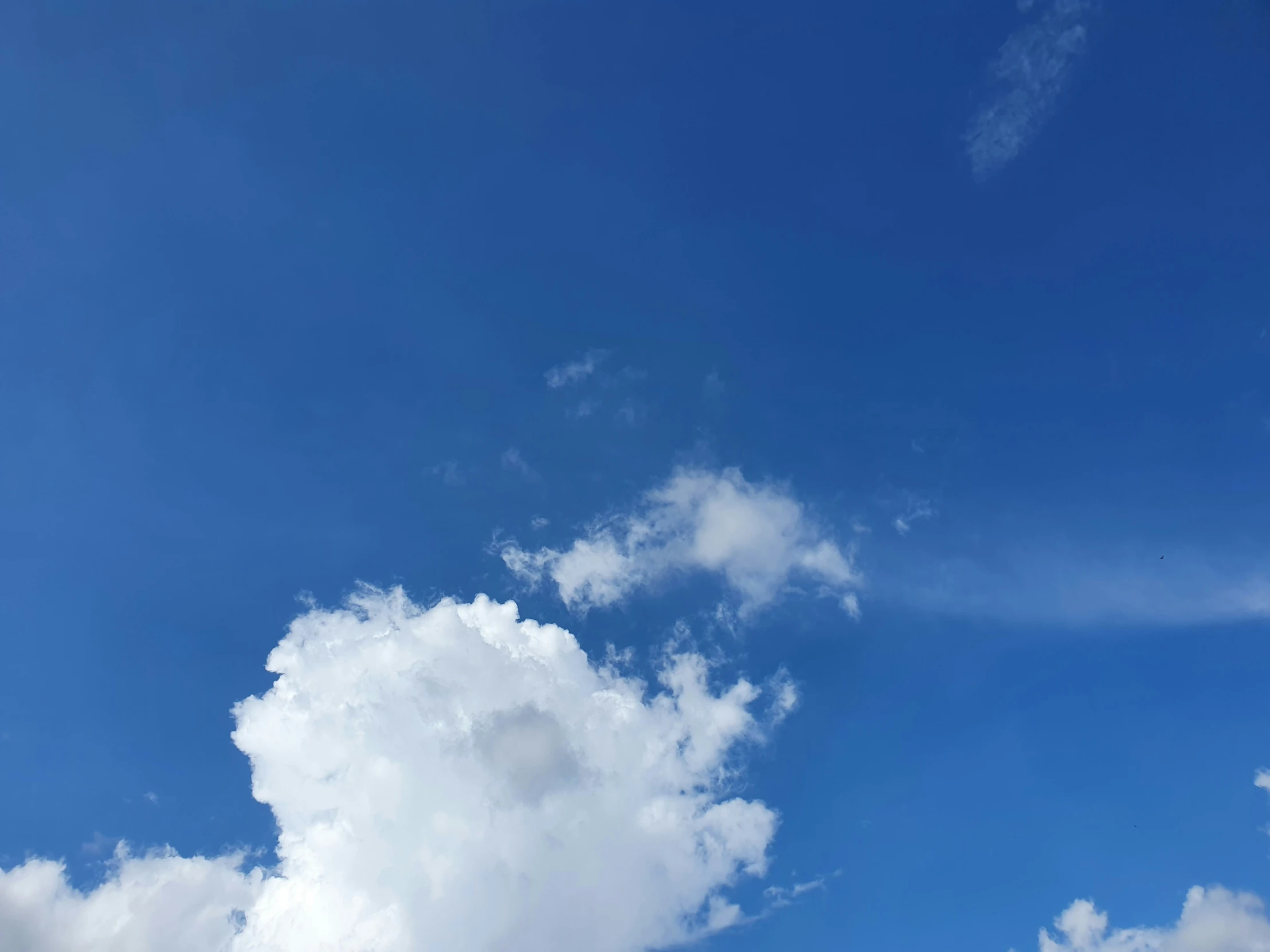 a clear blue sky with clouds in it