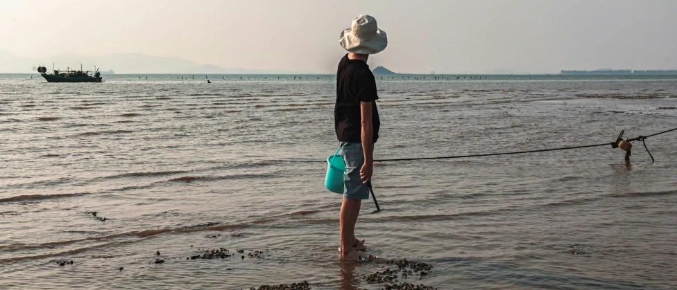 the man is looking out over the water to see the boats